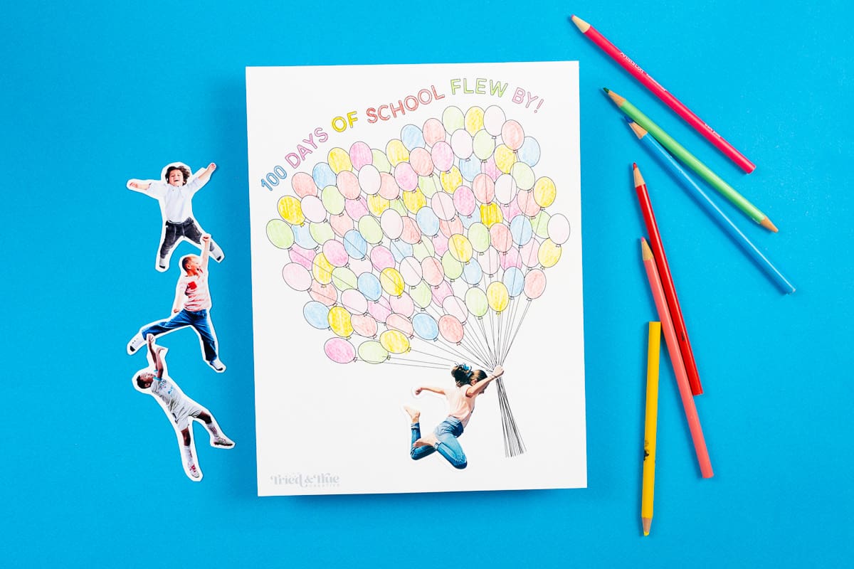 100 days of school free balloon free printableo n a blue background with colored pencils.