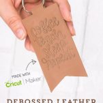 Hand holding debossed Leather Keychain with words 