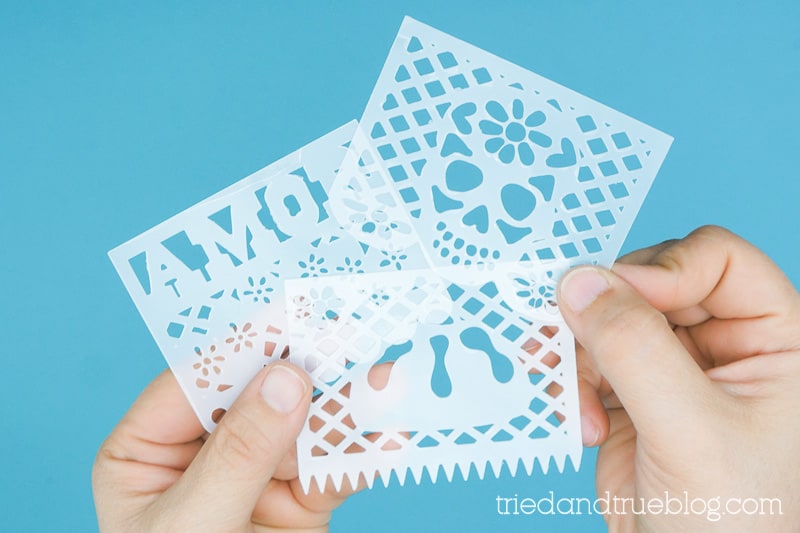 Cut shrink plastic with papel picado designs for Day of the Dead.