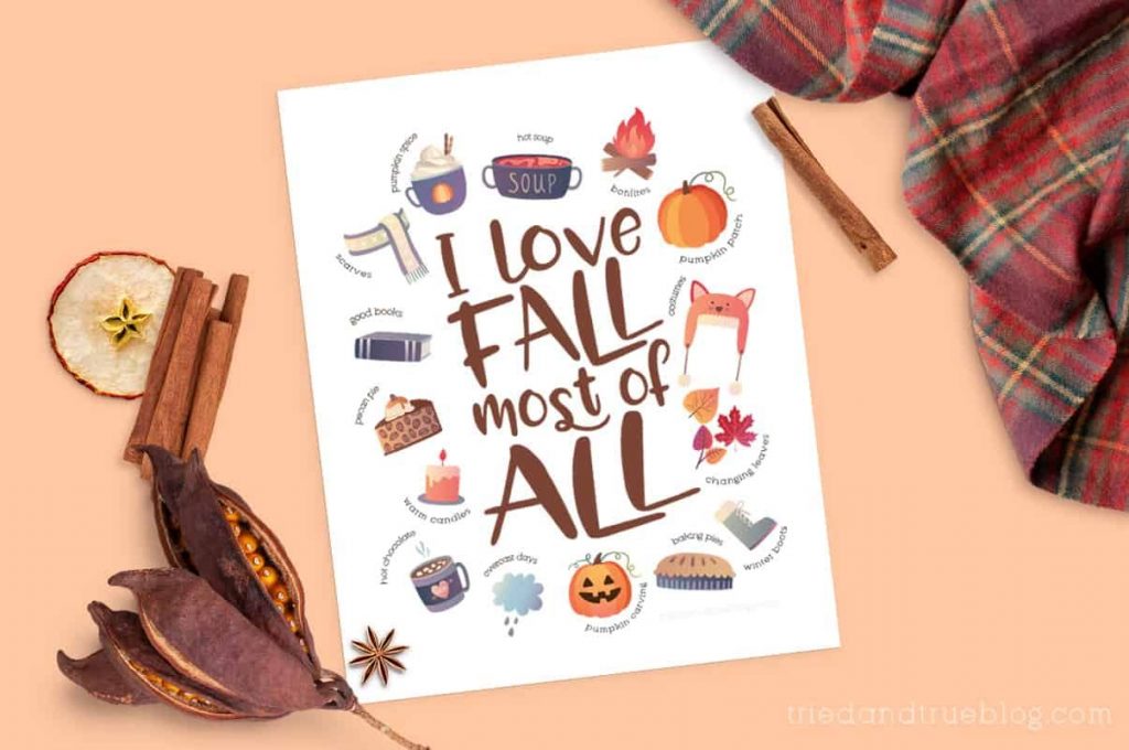 "I Love Fall" free printable surrounded by a scarf and cooking spices.