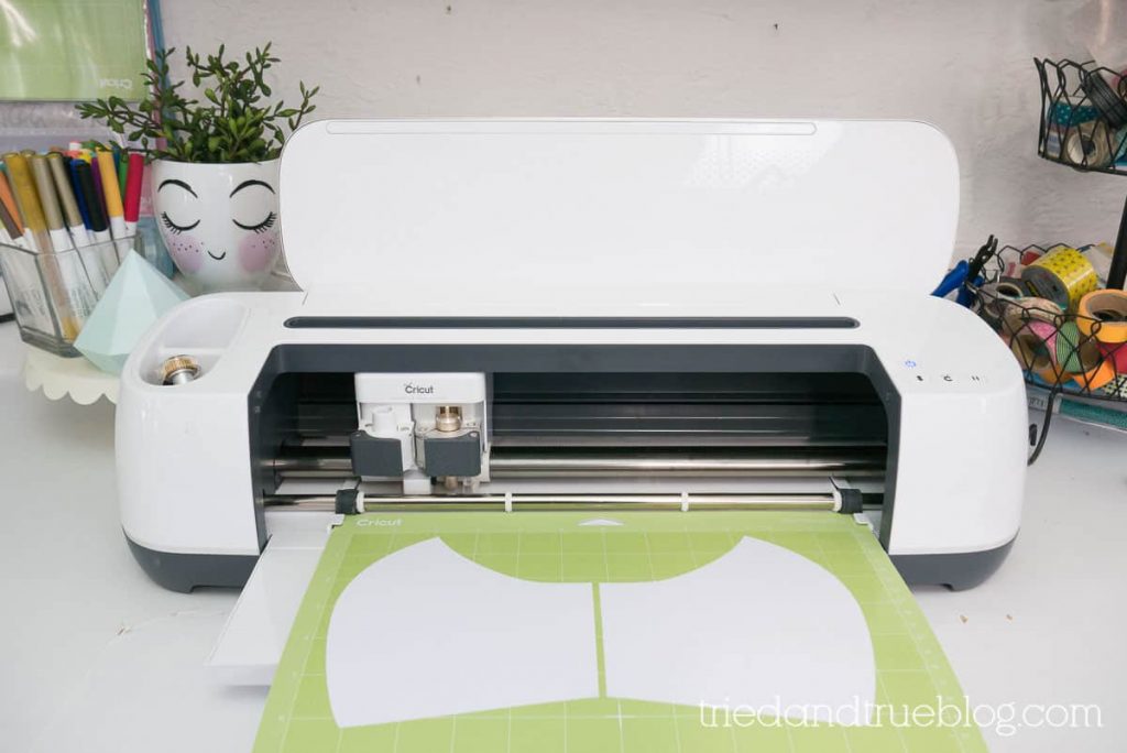 Image of Cricut Maker on a counter with craft supplies behind.
