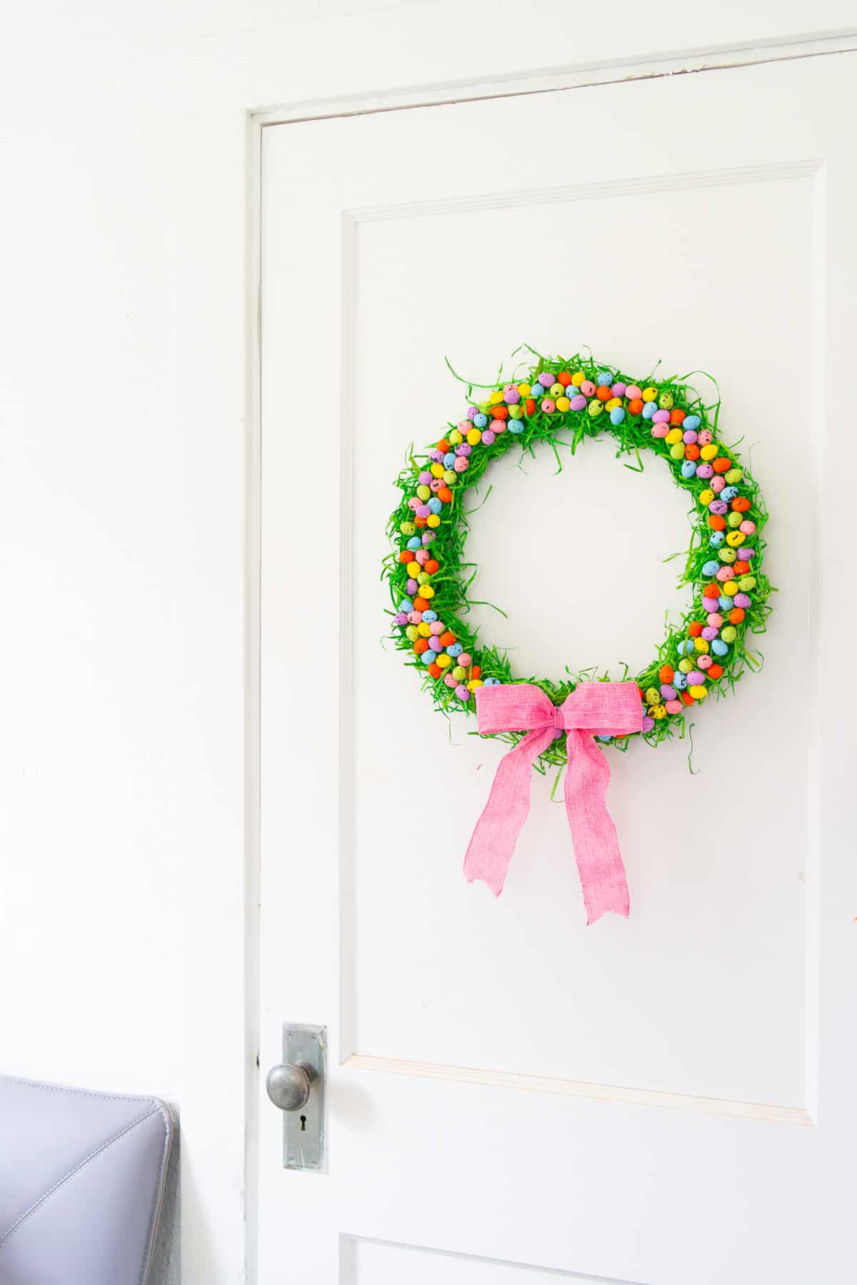 Spring wreath hanging on a white door.