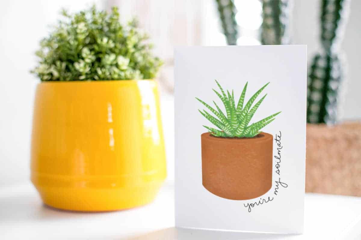 Succulent Valentine's Day Free Printable Card in front of two potted plants.