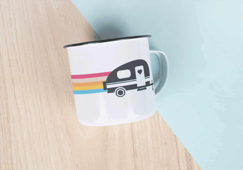 White enamel mug with rainbow and camper.